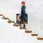 A woman standing on some steps, representing the moment before she feels ready to take the next step.
