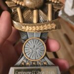 Charlie holding a cricket club supporter award that prompted a reflection on the high achiever mindset