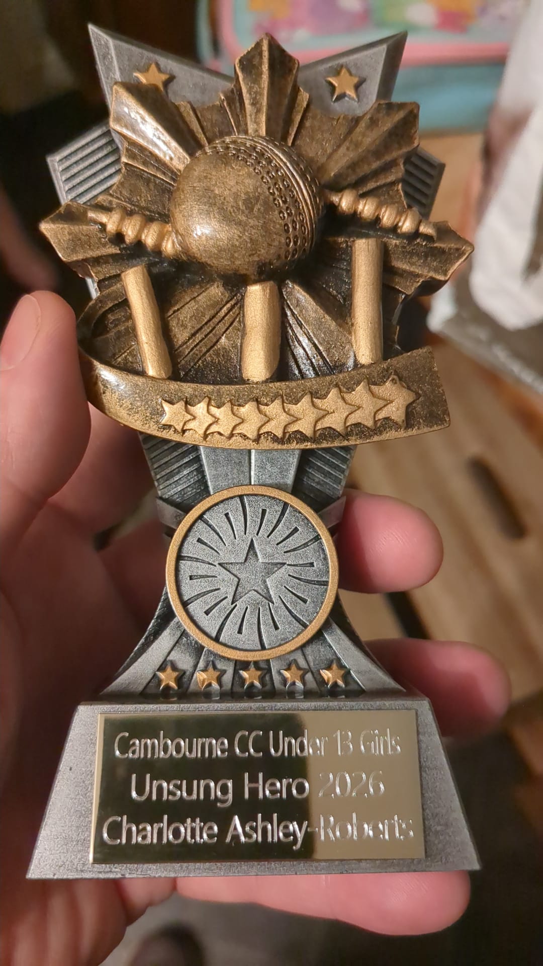 Charlie holding a cricket club supporter award that prompted a reflection on the high achiever mindset